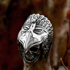 Vintage stainless steel eagle skull ring with oxidized finish in a forest setting
