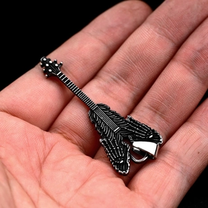 Macro shot of a stainless steel electric guitar pendant with skull bone carvings