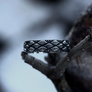 Gothic stainless steel vintage eye ring with intricate carvings on wood branch