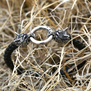 Vintage Viking wolf head stainless steel braided leather bracelet for men on rustic grass