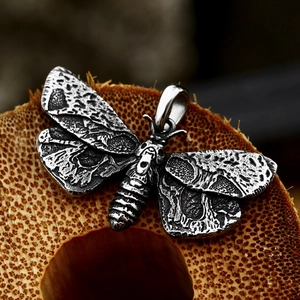 Vintage stainless steel moth pendant with gothic skull pattern and oxidized finish