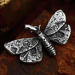 Vintage stainless steel moth pendant with skull motif and gothic etched details