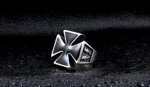 Macro shot of stainless steel biker ring featuring black enamel cross and lightning bolt relief