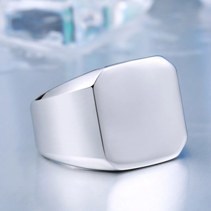Macro view of polished stainless steel signet ring with a smooth square face