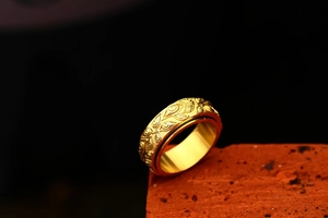 Vue détaillée d'une bague rotative en acier doré avec motif œil du diable vintage
