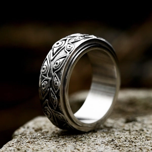 Macro shot of retro evil eye relief on vintage stainless steel ring on stone