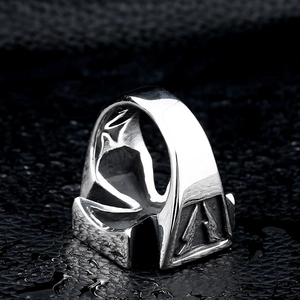 Rugged stainless steel ring with lightning cross relief on dark leather surface