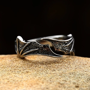 Vintage stainless steel angel wing ring with gothic punk feather design on natural stone