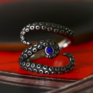 Adjustable octopus tentacle ring in vintage steel with blue gemstone center stone