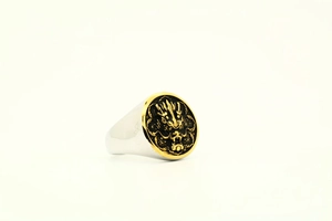 Detailed macro view of vintage titanium steel ring with embossed Chinese dragon motif