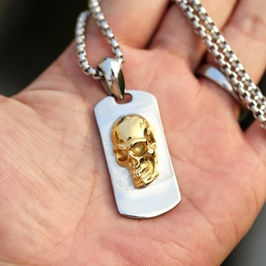 Vintage punk style military dog tag necklace featuring a 3D gold skull relief on steel