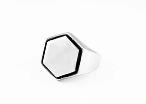 Macro shot of polished hexagonal surface with vintage black finish on stainless steel ring