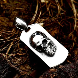 Vintage stainless steel skull tag pendant with a rustic finish for men in a natural setting