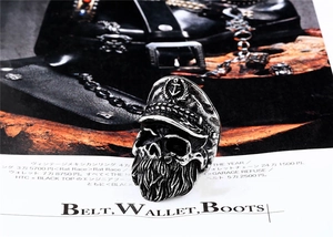 Macro detail of vintage anchor navy hat skull ring with beard design in stainless steel
