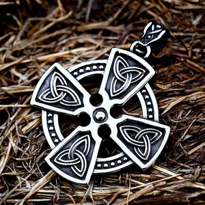 Vintage stainless steel Viking sun cross pendant with Celtic knots on straw background