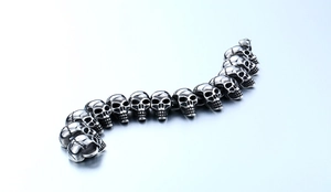 Macro shot of vintage silver skull links with detailed punk gothic metal craftsmanship