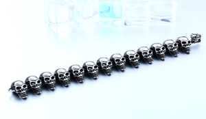 Detailed view of vintage silver skull link bracelet with rustic metallic finish and texture