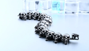 Detail of gothic skull link bracelet in brushed titanium steel with vintage finish