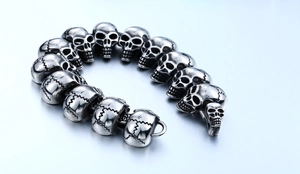 Macro side view of heavy punk style stainless steel skull link bracelet for men