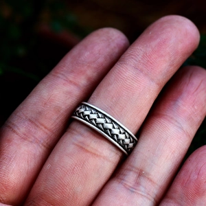 Gros plan sur une bague viking en acier inoxydable avec motif tressé argent antique