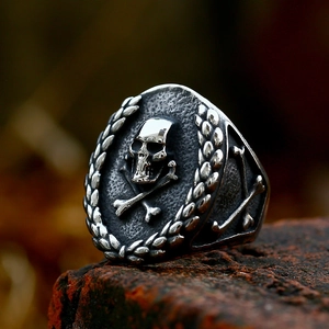 Vintage stainless steel skull and crossbones ring with gothic laurel leaf relief