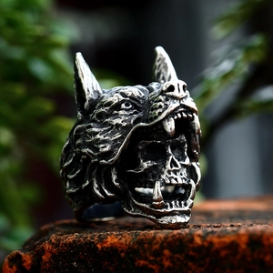 Gothic wolf head skull ring in vintage stainless steel on a textured brick background