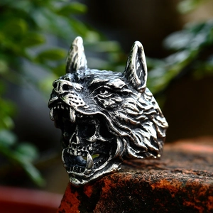 Gothic wolf head stainless steel ring with skull detail on rustic brick background