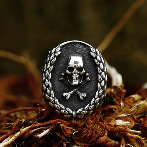 Macro detail of gothic skull and crossbones emblem on a vintage stainless steel ring