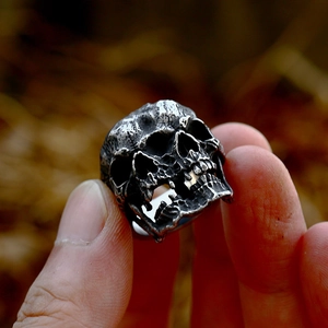 Detailed close-up of retro punk double skull ring with blackened oxidized texture