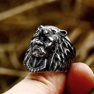 Detailed close-up of a vintage stainless steel chieftain ring with turquoise and bear head