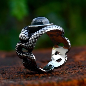 Vintage stainless steel snake ring with embossed scales and a large dark blue gemstone