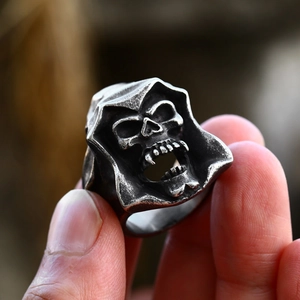 Macro view of vintage stainless steel Grim Reaper skull ring with detailed aged finish