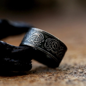 Detail shot of vintage stainless steel wide ring with Celtic knot and dragon motifs
