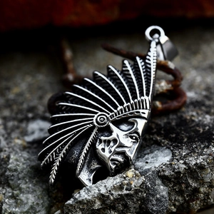 Vintage stainless steel native american indian chief pendant on dark rock background