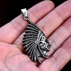 Macro detail of vintage stainless steel Indian chief pendant with retro feather texture