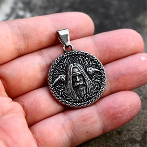 Macro shot of vintage stainless steel Viking Odin pendant with crows and Celtic knots