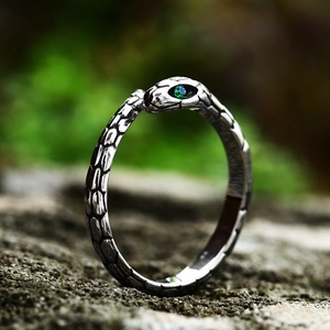 Vintage stainless steel snake ring with realistic scale texture and green gemstone eyes