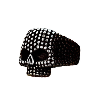 Gothic punk skull ring in black oxidized finish with silver dots on white background