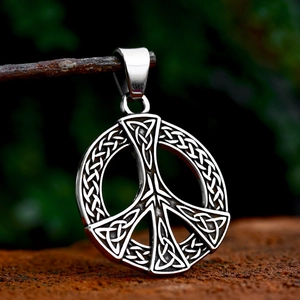 Vintage stainless steel peace sign pendant with intricate Celtic knot patterns on a branch
