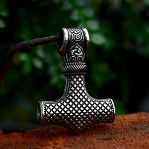 Vintage Thor's Hammer pendant with Nordic runes in retro silver finish on rustic bar