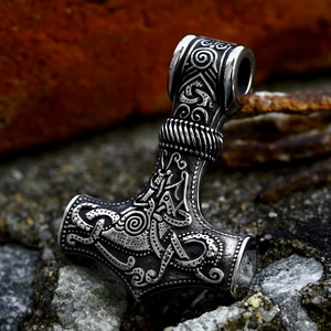 Vintage Mjolnir pendant with Celtic knots in stainless steel on stone background