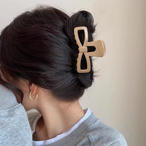 Khaki soft resin bow hair claw clip for thick hair shown on model back view