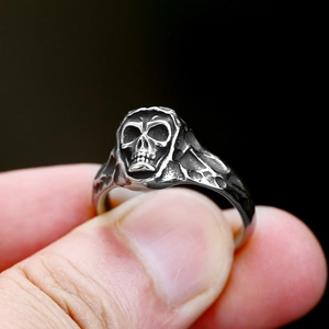 Macro shot of punk style stainless steel skull ring with vintage silver finish for men