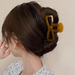 Elegant amber bow hair claw clip in translucent UV finish for stylish women hairstyles