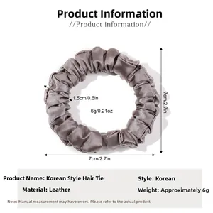 Gray silk satin scrunchie detail with 7cm diameter and 1.5cm width dimensions