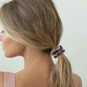 Greyish purple silk satin scrunchie shown on a ponytail with elegant pleats and soft shine
