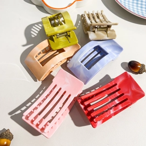 Detail view of square marble texture hair claw clips set in six assorted vibrant colors