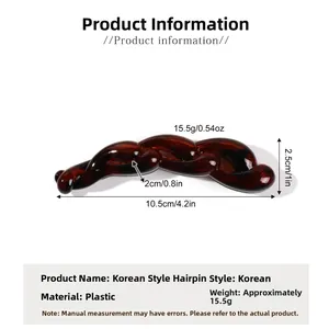 Macro view showing the dimensions and curved teeth of this amber leopard banana hair clip