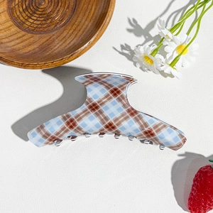 Detailed view of brown and blue plaid claw clip with smooth resin finish for high ponytails