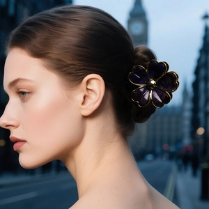 Elegant purple flower hair claw clip with gold plated edges worn by woman on street